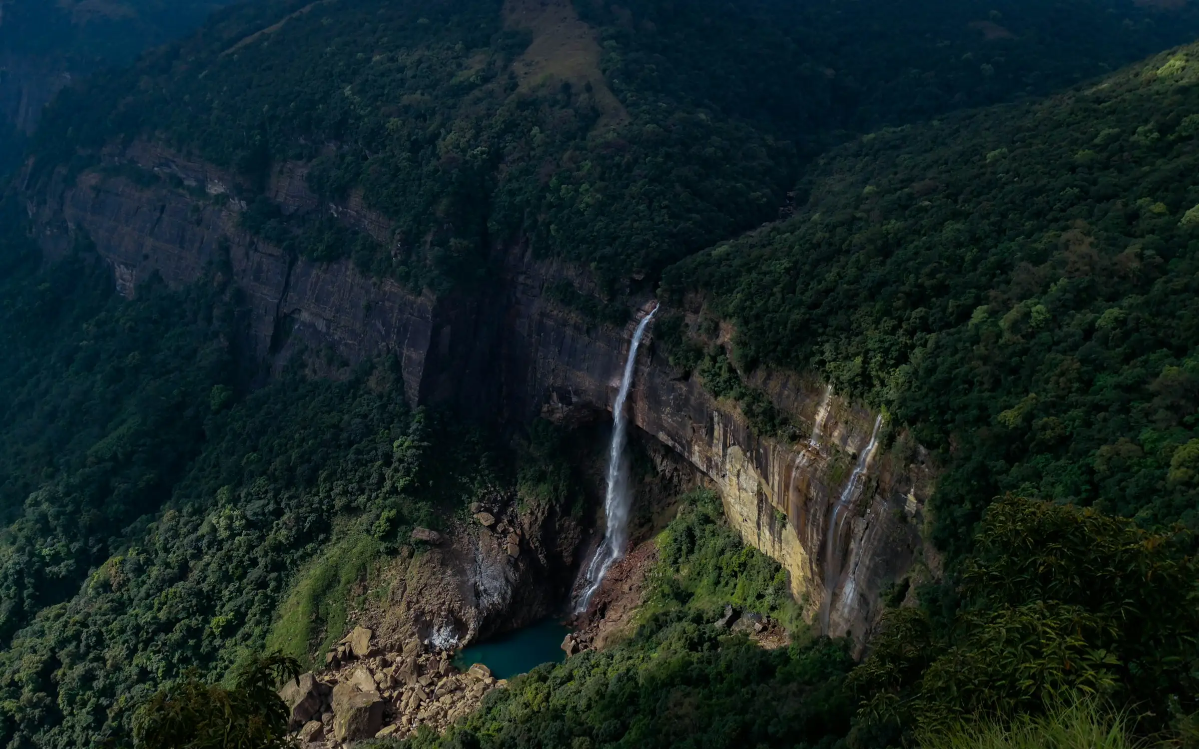 Nohkalikai Falls cutting through the lush green cliffs of Meghalaya